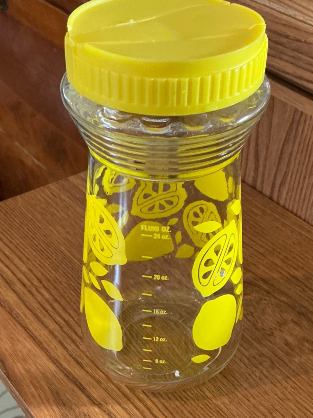 Vintage yellow lemon juice mixer glass jar with measurements on side